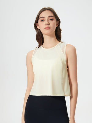 Pastel Yellow cropped active tank with mesh shoulder insets.