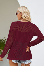Burgundy openwork knit tunic with long sleeves and a V-neckline, showing a chevron pattern detail.