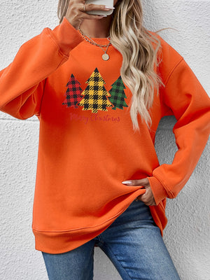 Orange crewneck sweatshirt with plaid Christmas trees graphic and Merry Christmas text.