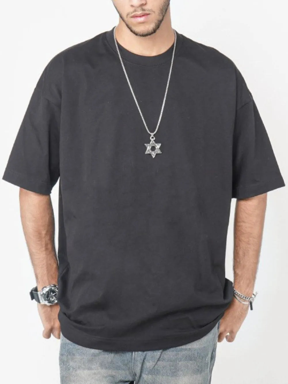 Black oversized crew neck t-shirt with short sleeves and a relaxed fit.