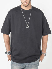 Black oversized crew neck t-shirt with short sleeves and a relaxed fit.