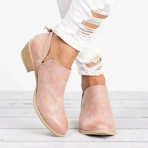 Pink V-cut pointed toe block heel boots with side cutouts and a back tab detail.