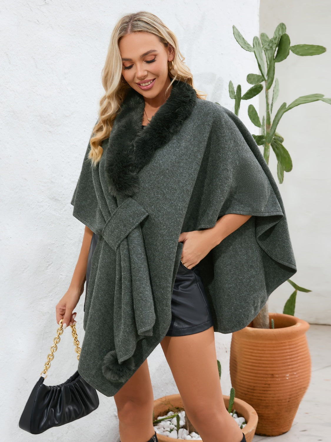 Dark green faux fur collar wrap poncho with tie detail and pom-pom accents.