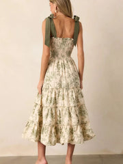Floral tiered midi dress with smocked bodice and tie straps in cream with green botanical print.
