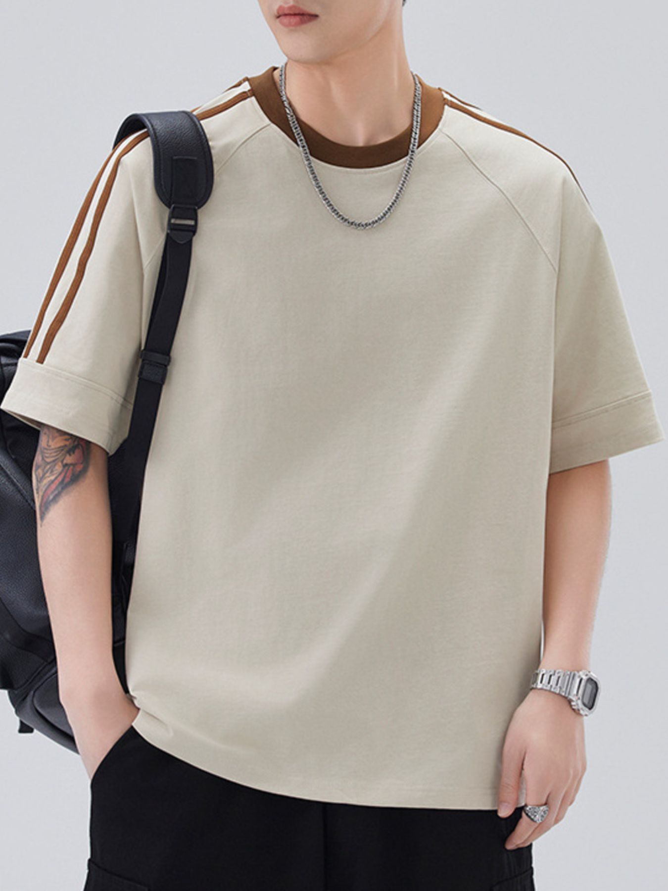 Oversized beige cotton blend t-shirt with contrast brown stitching on sleeves and neckline.