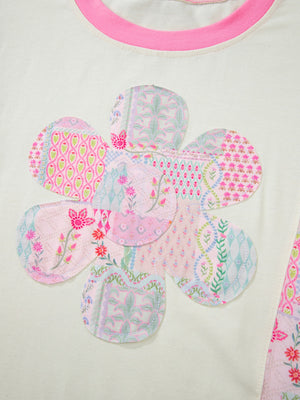 Cream cotton crew neck t-shirt with a large floral patchwork applique and pink trim.