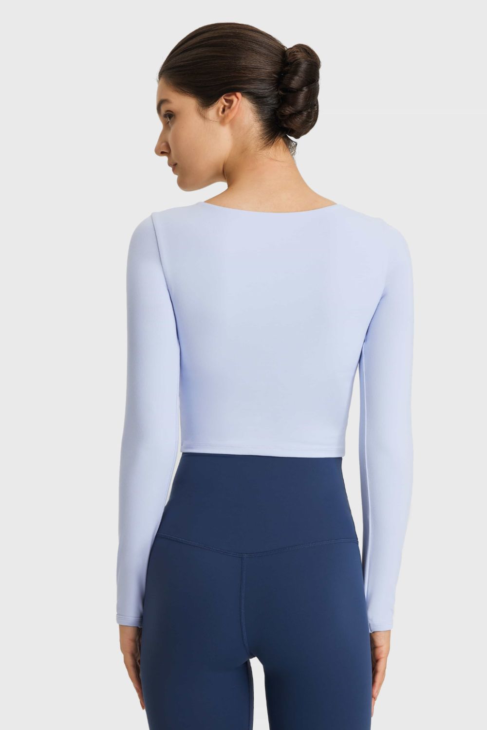 Sky blue crop top with thumbhole sleeves and a boat neckline.