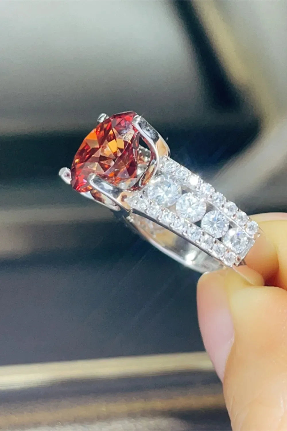 Crimson solitaire ring with pave diamond band