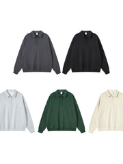 Oversized polo sweatshirt with collar in dark gray, black, dark green, gray, and tan.