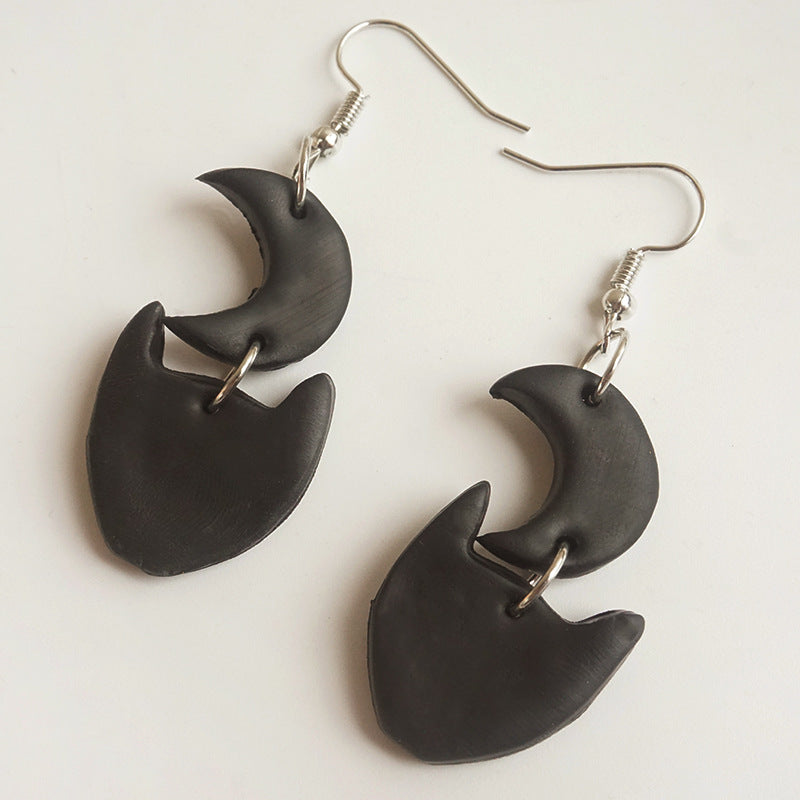 Black Halloween charm drop earrings featuring crescent moon and cat face charms.