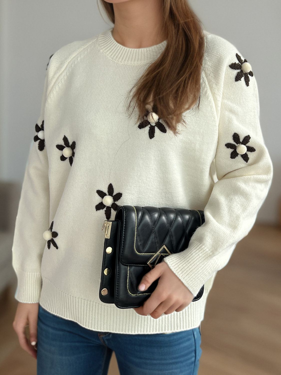 Cream embroidered floral raglan knit sweater with beaded flower details.