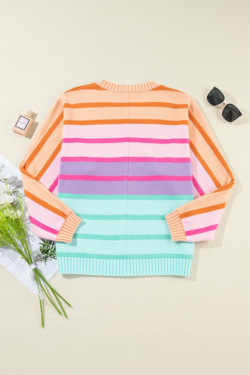 Ombre stripe knit sweater with ribbed cuffs in sherbet and turquoise colors.