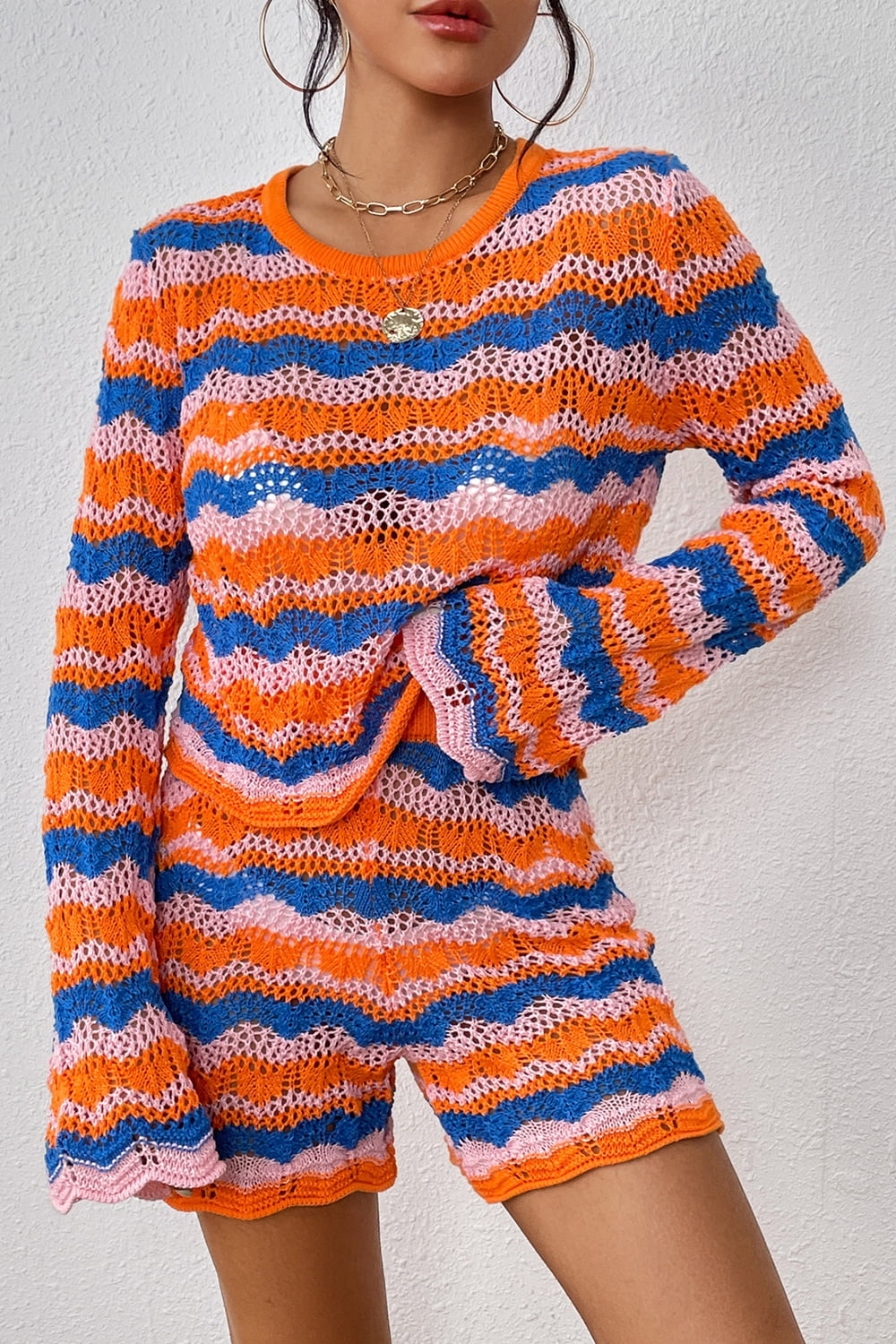Crochet flare set in orange-red with blue and pink wavy stripes and bell sleeves.