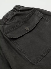 Black cargo pants with elastic waistband and button-flap pocket detail.