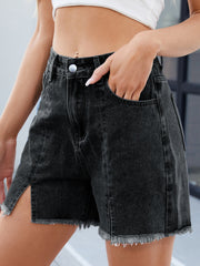 Black denim shorts with split front, frayed hem and raw edges.