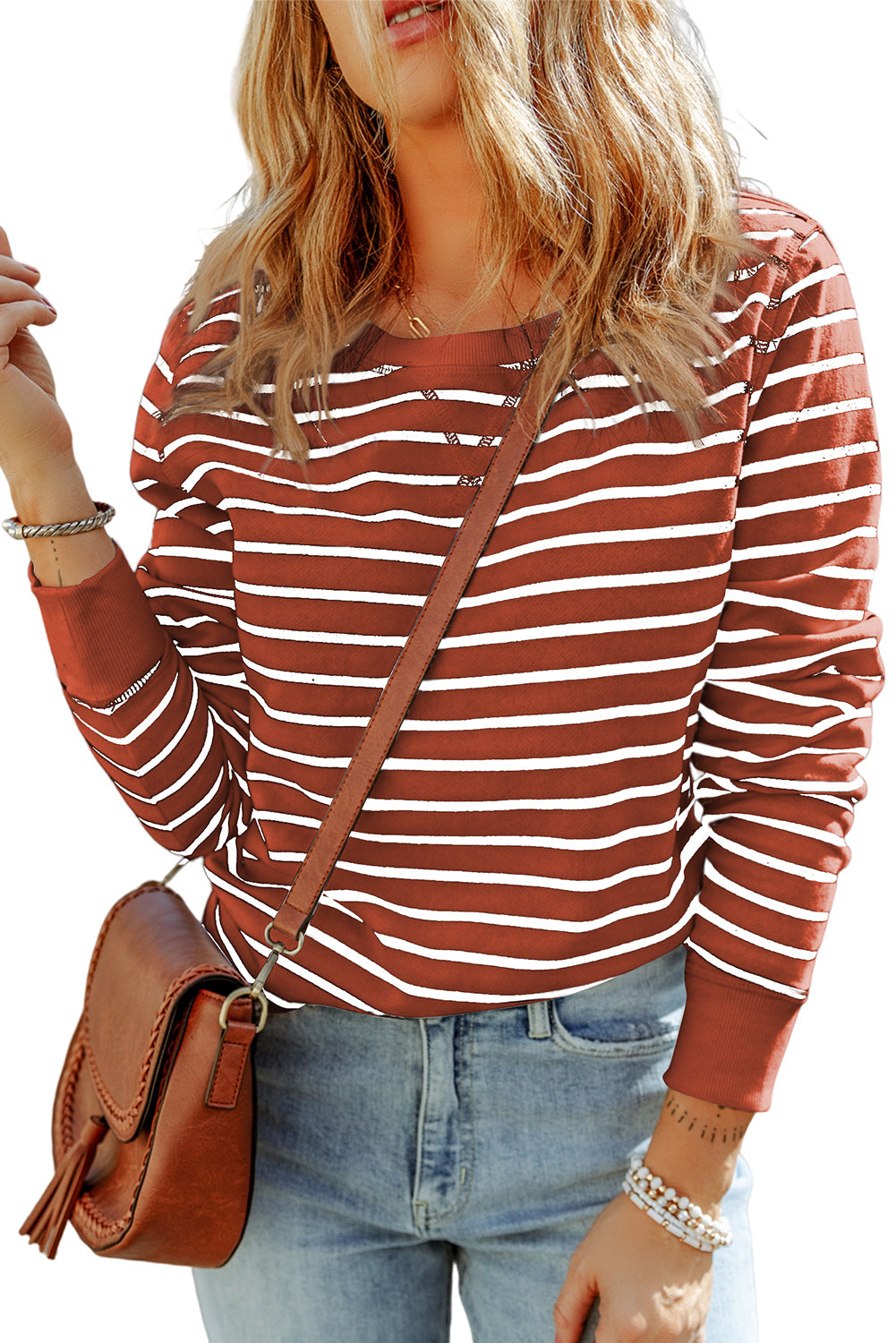 Nautical stripe crewneck sweatshirt in red orange with white stripes, long sleeves, and crew neckline.