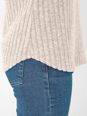 Relaxed fit ribbed V-neck t-shirt in light beige, showing hem detail.