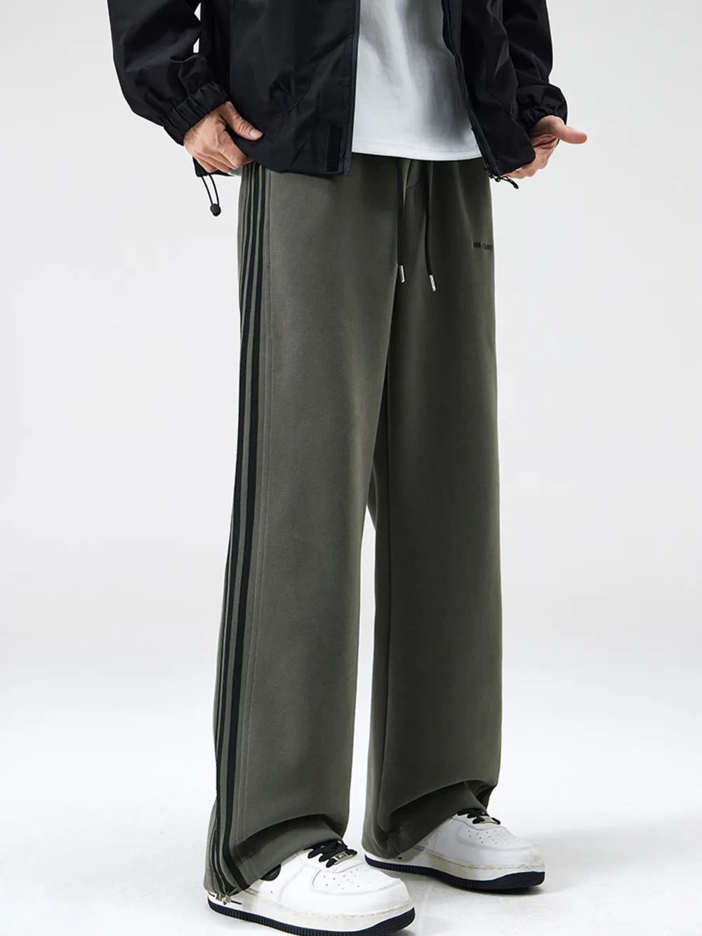 Men's army green sweatpants with black side stripes and drawstring waist