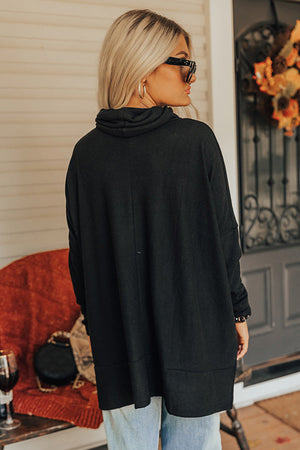 Black drape-front cowl neck tunic with long sleeves and a relaxed fit.