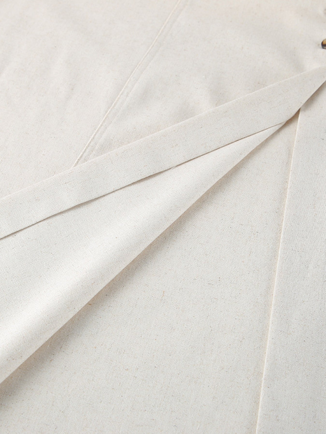 Button front tube maxi dress in beige cotton blend fabric with visible button detail.