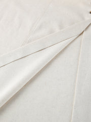 Button front tube maxi dress in beige cotton blend fabric with visible button detail.