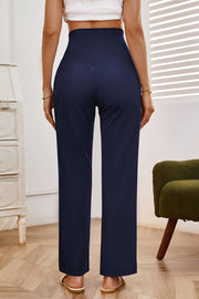 Navy high-waisted flare leg trousers with a v-seam detail, shown from the back.