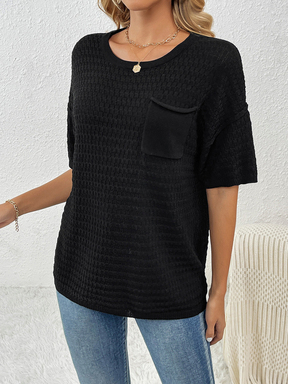Black textured knit t-shirt with boxy silhouette and chest pocket