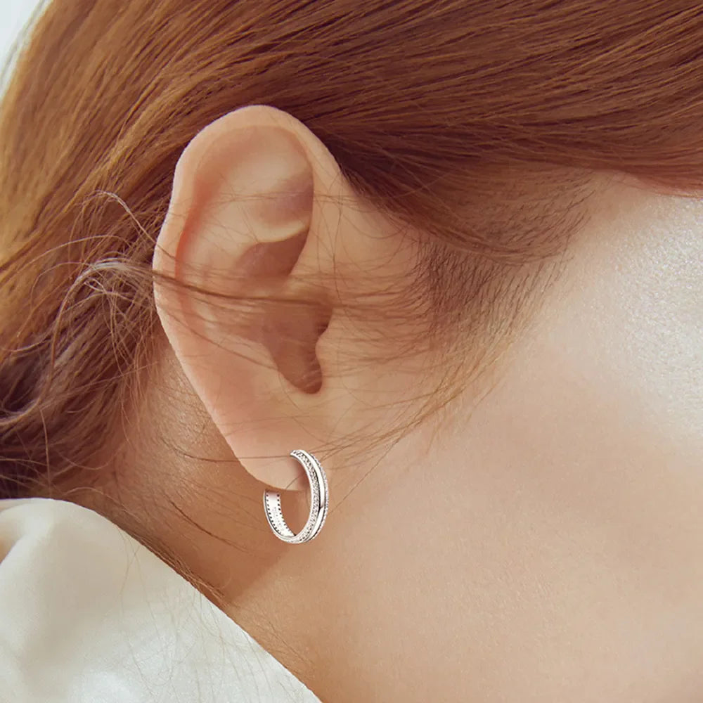 Silver pavé moissanite C-hoops in sterling silver with double band detail.