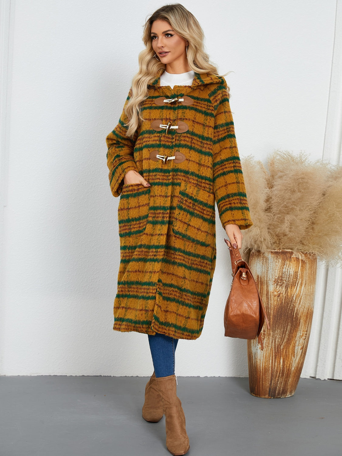 Tartan toggle hooded coat in mustard with green stripes, featuring wooden toggles and front pockets.