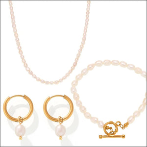 Gold pearl jewelry set with necklace, bracelet, and hoop earrings.