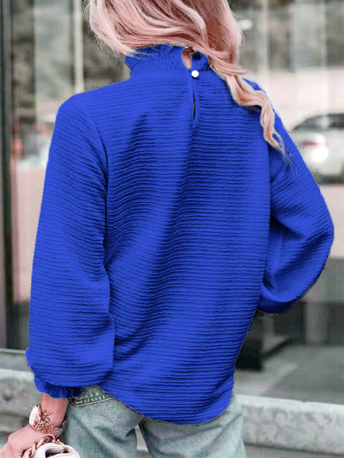 Royal blue textured puff sleeve blouse with smocked neck and buttoned back detail.
