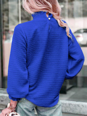 Royal blue textured puff sleeve blouse with smocked neck and buttoned back detail.