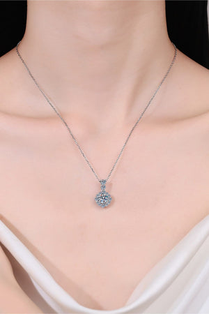 Halo moissanite pendant necklace in sterling silver with a delicate chain.