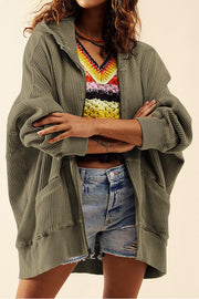 Army green waffle knit zip-through hoodie with pockets and a hood.