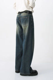 Faded wash wide-leg denim jeans in medium with a relaxed fit and distressed details.