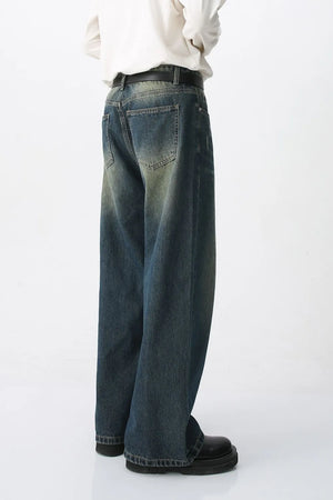 Faded wash wide-leg denim jeans in medium with a relaxed fit and distressed details.