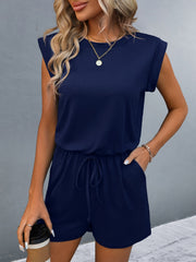 Dark blue shoulder pad romper with drawstring waist and pockets