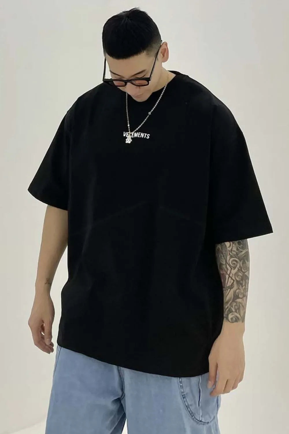 Black oversized t-shirt with white logo detail and crew neck