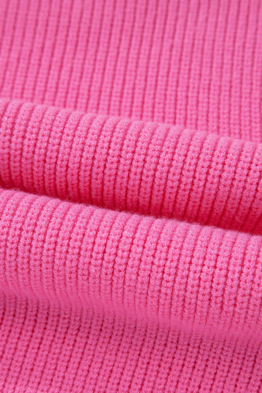 Fuchsia pink ribbed knit vest detail showing textured fabric.