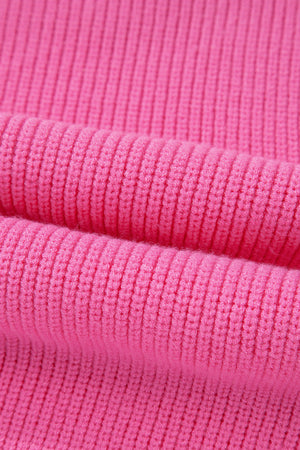 Fuchsia pink ribbed knit vest detail showing textured fabric.