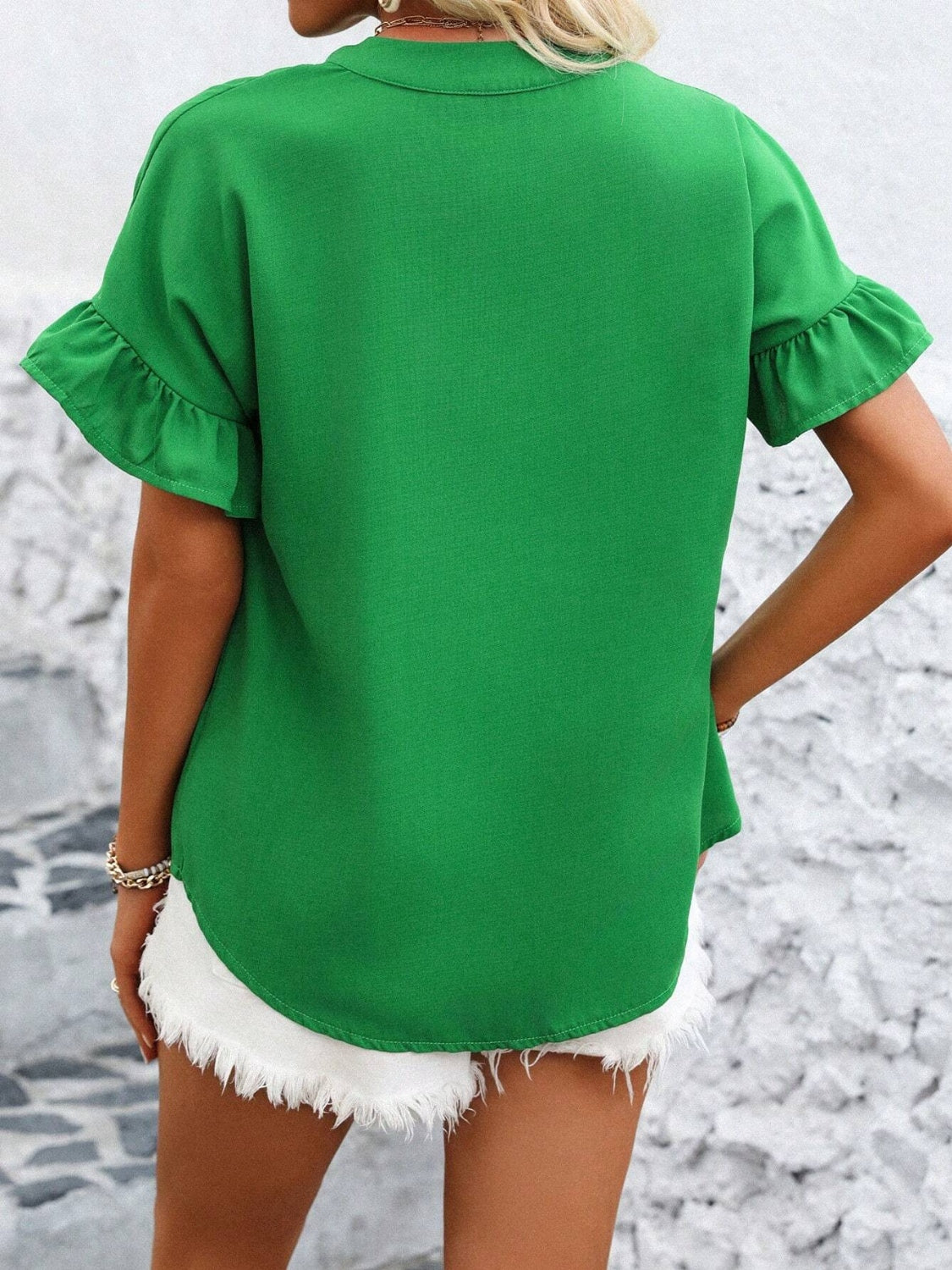 Green blouse with ruffle sleeves and gathered yoke detail.