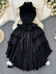 Black ruffled tiered midi dress with belted waist and frill details.