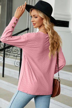 Blush pink diamond-textured V-neck blouse with button cuff detail
