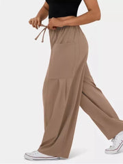 Tan jeggings with drawstring waist and cargo pockets, wide-leg cut.