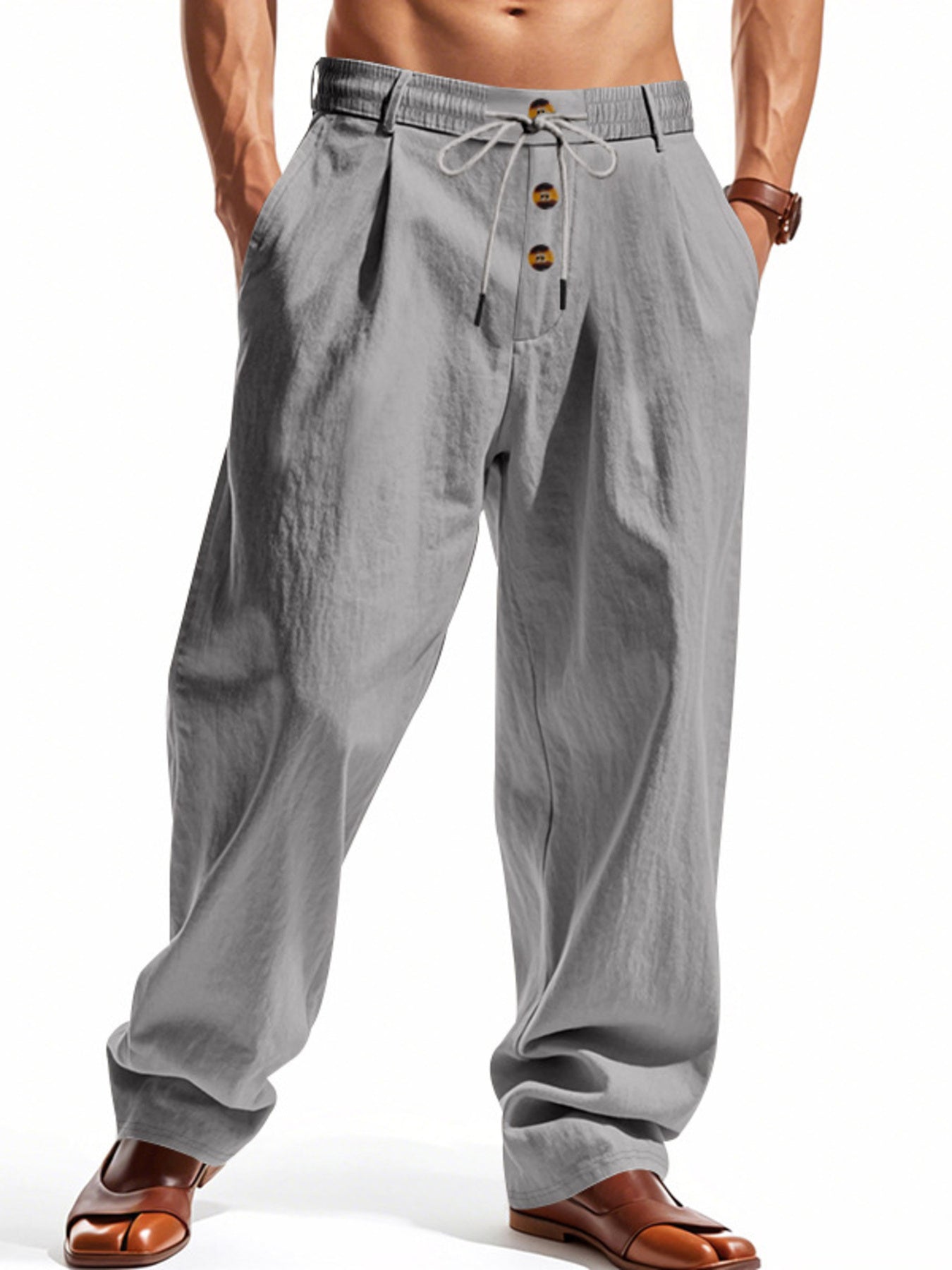 Men's grey loose fit drawstring pants with button fly and pleats.