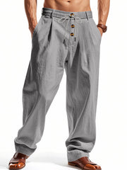 Men's grey loose fit drawstring pants with button fly and pleats.