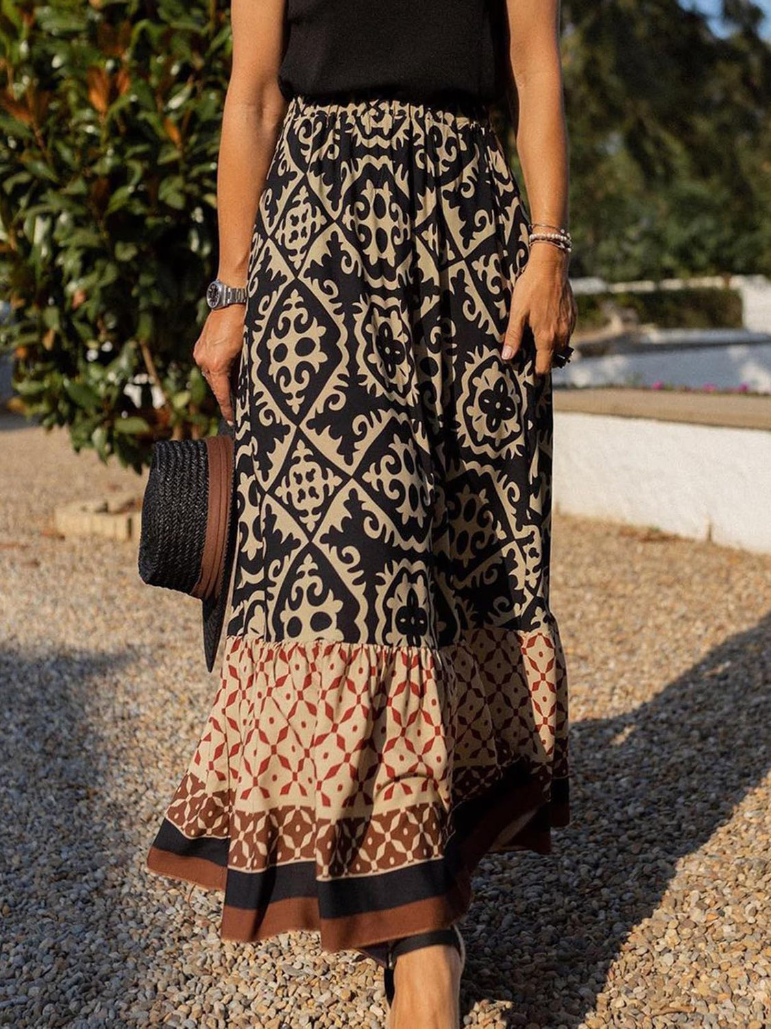 Tiered maxi skirt in black with medallion print and a ruffled hem.