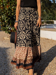 Tiered maxi skirt in black with medallion print and a ruffled hem.