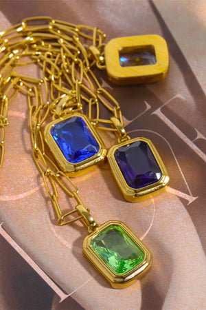 Gold chain necklace with royal blue, purple, and light green rectangular gemstone pendants.