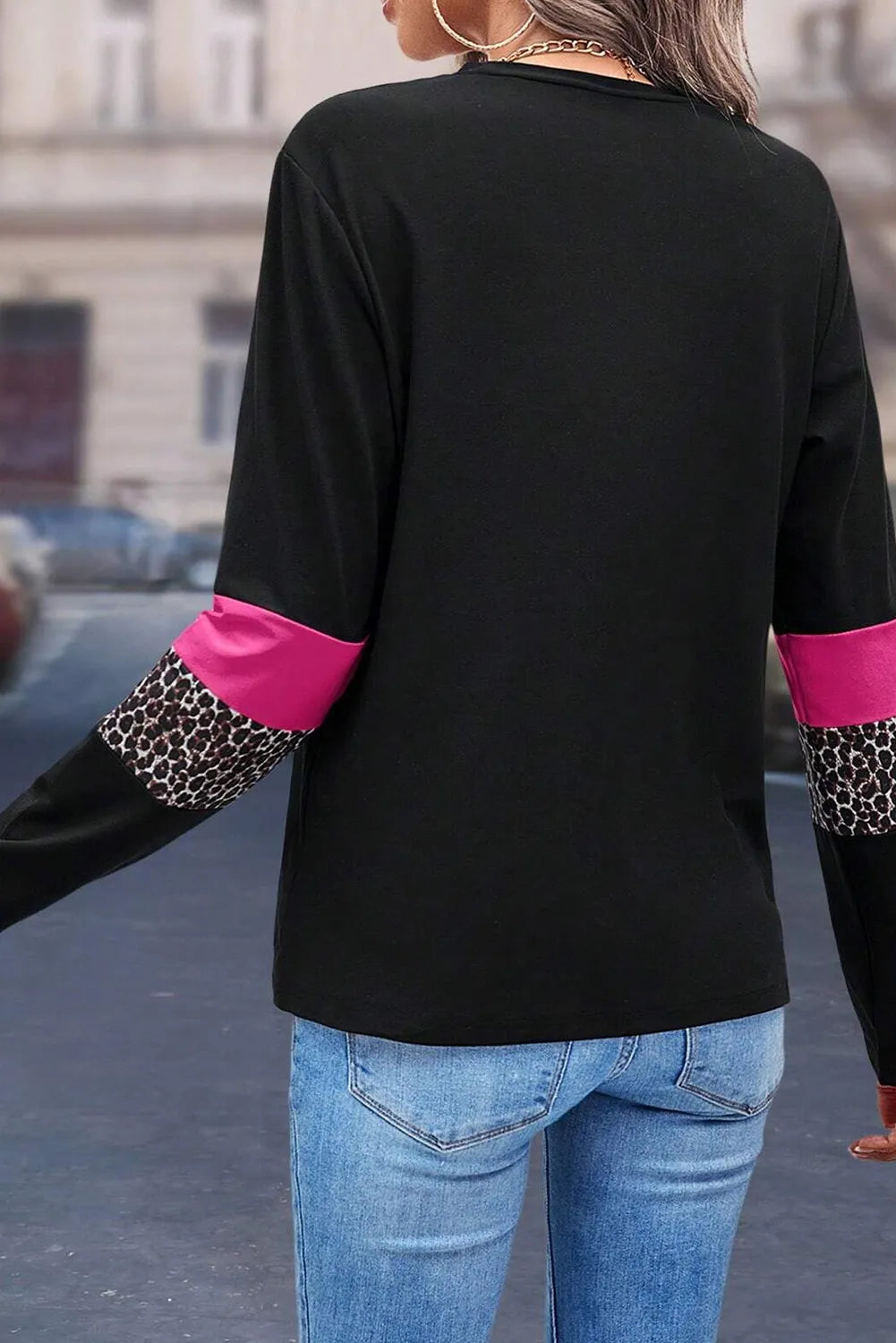 Black long sleeve tee with fuchsia pink and leopard print panel details on sleeves.